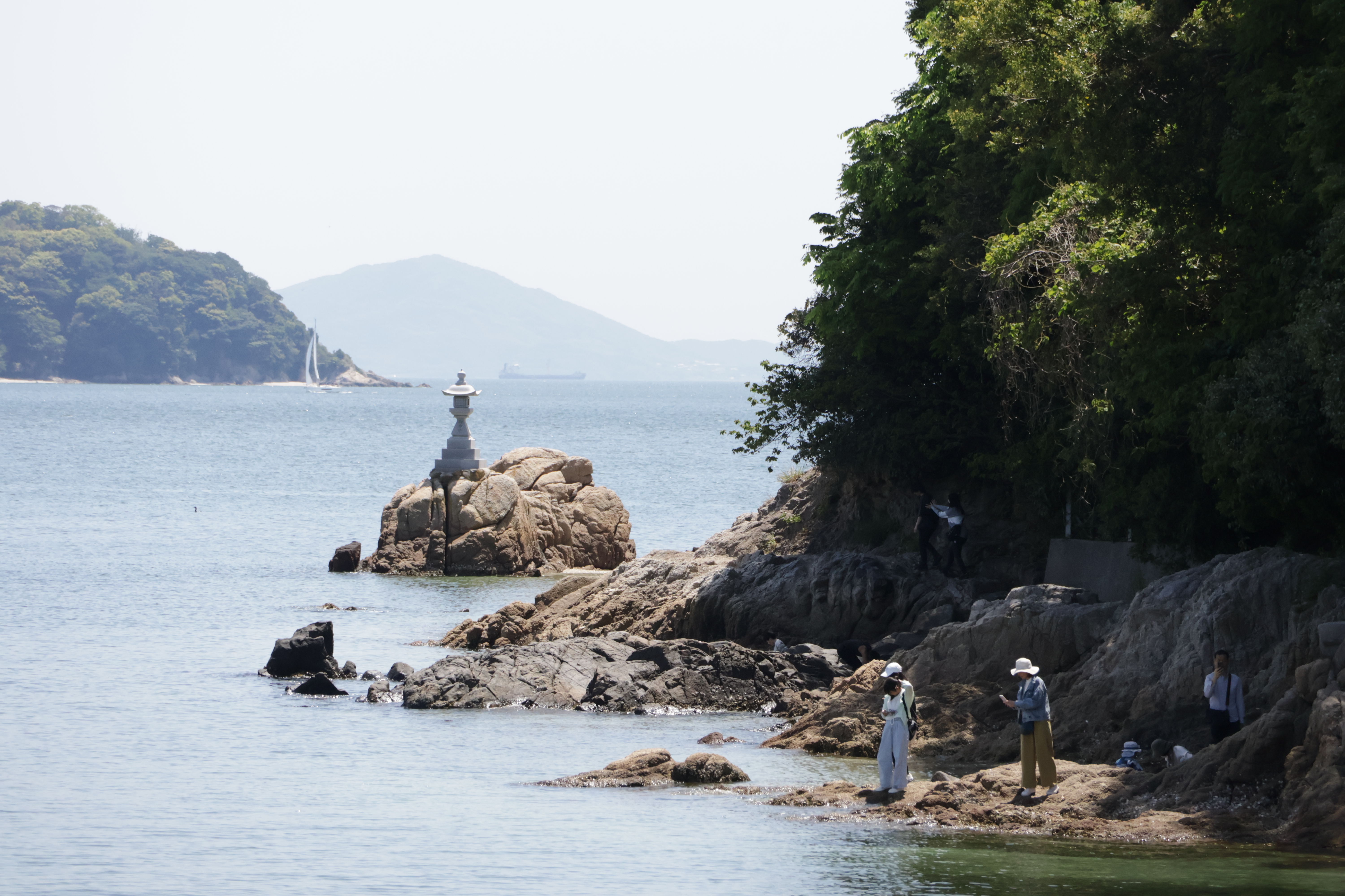 Tourists exploring Takeshima's shores.